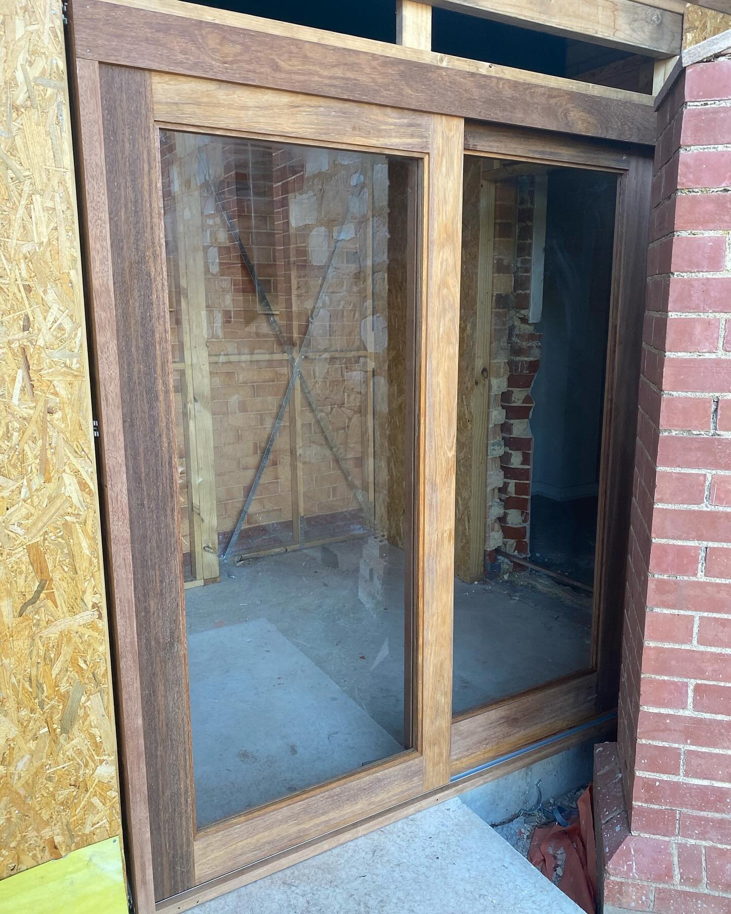 Timber-framed double window unit installed in a new brick extension opening