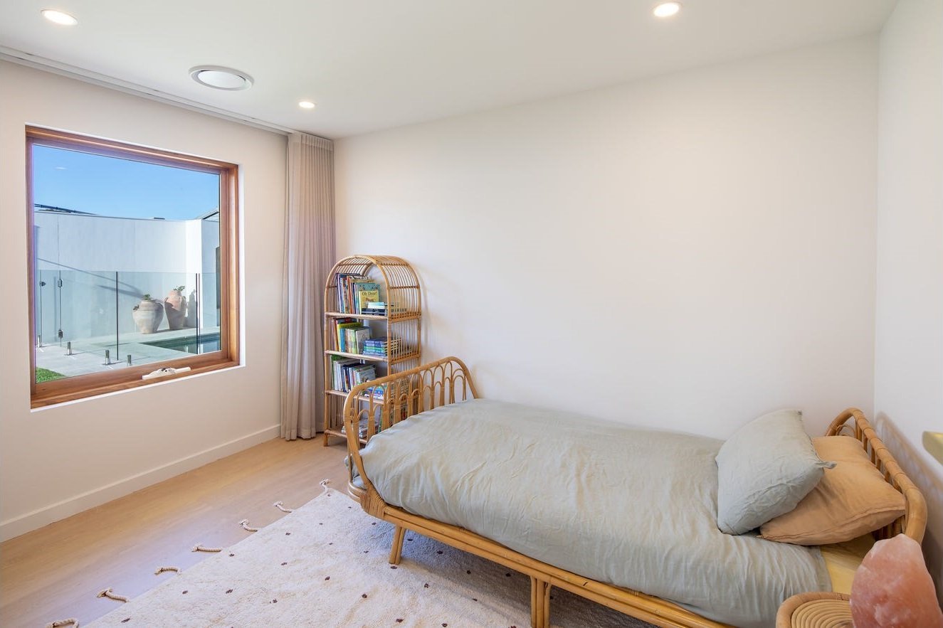 Timber-framed awning window overlooking the pool, bedroom interior