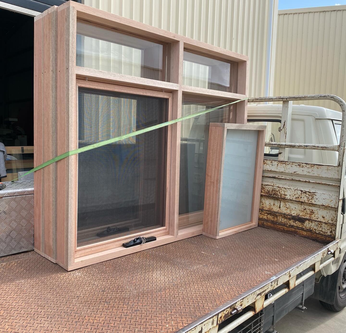 Timber awning windows and fixed glass panels loaded on the delivery truck