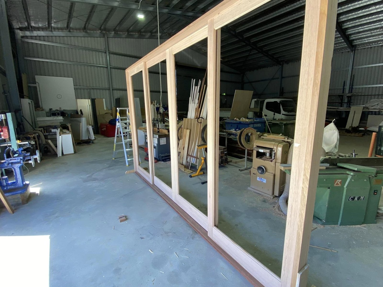 Four-panel timber bifold door assembled and glazed in the workshop, ready for delivery