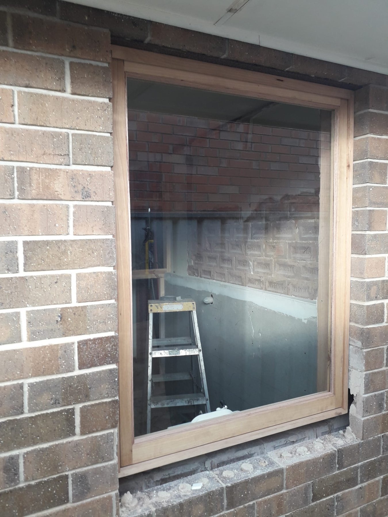 Vic Ash fixed window installed in a brick bathroom extension, construction in progress
