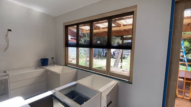 Four-panel timber servery window with fitted blinds above a new kitchen island bench