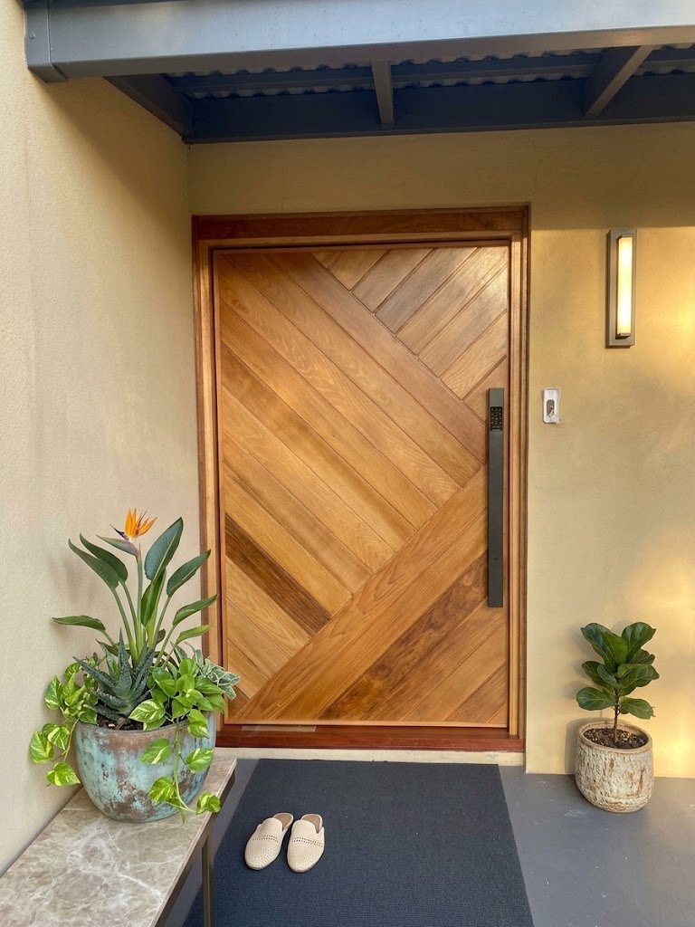 Feature pivot entry door, diagonal timber panels