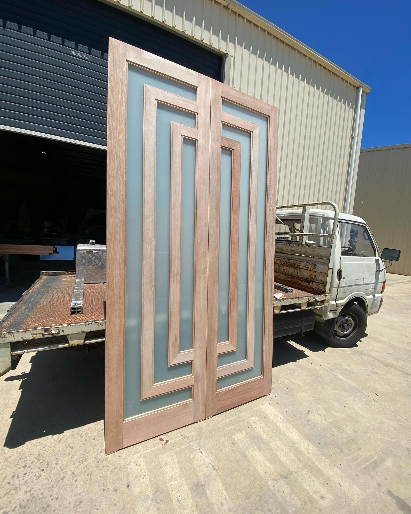 Modern double doors with geometric timber mullions over frosted glass panels